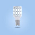 LED energy saving lamp 230v in a ceramic socket on blue pastel color background Royalty Free Stock Photo