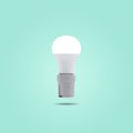 LED energy saving lamp 230v in a ceramic socket on green pastel color background Royalty Free Stock Photo