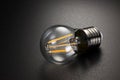 LED filament light bulb on black background Royalty Free Stock Photo