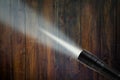 LED flashlight beam on wooden background Royalty Free Stock Photo