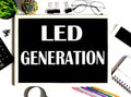 LED GENERATION on the drawing board with office tools Royalty Free Stock Photo