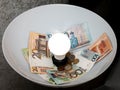 LED lamp and Belarusian banknotes and coins in the plafond. Electricity costs.