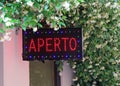 LED lighted sign with the text APERTO Which means OPEN  in the I Royalty Free Stock Photo