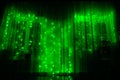 Led luminous garland with green lights on a dark background. Royalty Free Stock Photo