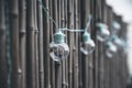 LED mint color light bulbs hanging on a bamboo screen wall outside on a deck Royalty Free Stock Photo