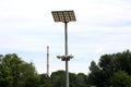 LED modern street light reflectors pointed towards large reflective panels mounted on top of strong metal pole with industrial