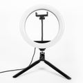 LED ring lamp on a small tripod. White background
