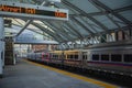 An LED sign displaying, Airport trk1 00min, and the A line light rail train departing Denver Union Station on a cold winter day