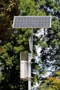 LED traffic sign mounted on strong metal pole and powered with small solar panel on top in local public park Royalty Free Stock Photo