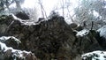 Ledge with icicles in picturesque winter wonderland scenery in dense snowfall