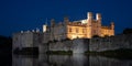 Leeds Castle in Kent UK, illuminated at night and reflected in the surrounding water. Royalty Free Stock Photo