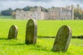 Leeds Castle near Maidstone, Kent UK. Tombstones in foreground. Photographed on a crisp, clear day in autumn.