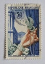 N old blue french postage stamp with an image of a female hand holding stylish jewelry Royalty Free Stock Photo