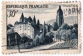 An old blue french postage stamp with an image of the town of arbois Royalty Free Stock Photo