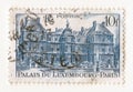 An old blue vintage french postage stamp with an image the palace of Luxembourg in Paris Royalty Free Stock Photo