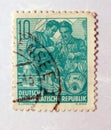 An old green east german postage stamp a design featuring two engineers