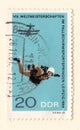 An old blue east german postage stamp commemorating a skydiving event in Leipzig in 1966