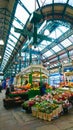 seller selling flowers in a flower shop with colourful and blooming flowers in the interior of Leeds Kirkgate Market