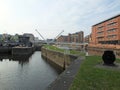 the leeds lock entrance to clarence dock with footbridge over the river aire and historic gates and mooring area surrounded by