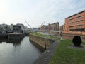 Leeds lock entrance to clarence dock with footbridge over the river aire and historic gates and mooring area Royalty Free Stock Photo
