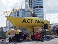 The large yellow boat banners and people in the road at the extinction rebellion protest blocking victoria bridge in leeds