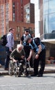 Police liaison officers helping a man in a wheelchair at the extinction rebellion protest blocking the road at victoria bridge in