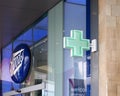 Sign green pharmacy cross above the boots chemists store in briggate leeds