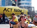 A young woman juggling in front of the big yellow boat at the extinction rebellion protest blocking the road at victoria bridge in