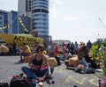 A young woman juggling in front of the big yellow boat at the extinction rebellion protest blocking the road at victoria bridge in