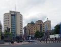 Buses and pedestrians crossing the road in city square leeds with tall office buildings of park row Royalty Free Stock Photo