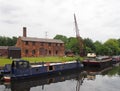 Houseboats moored outside thwaite mill in knostrop leeds with people on boats and historic watermill in the background Royalty Free Stock Photo