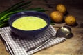 Leek cream soup with fresh spring onions and potatoes on rustic Royalty Free Stock Photo