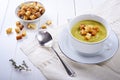 Leek and potato soup with croutons on white wooden background. Royalty Free Stock Photo