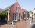 Pedestrians and people on bicycle pass house of poet wilhelmine siefkes in old german town of leer