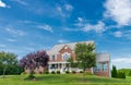 Country modern mansion in traditional American style. large green lawn and trees