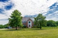 Country modern mansion in traditional American style. large green lawn and trees