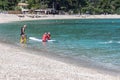 Seniors enjoying beach based leisure activities in the sea off Agios Ioannis beach, Lefkada, Greece