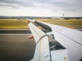 A Left Aircraft wing landing on a runway. Royalty Free Stock Photo