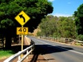 Left curve ahead sign and speed limit sign