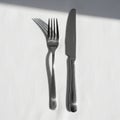 The left with four tines and the knife on the right features a Royalty Free Stock Photo