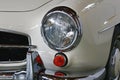 Left front headlight and part of front chrome buffer on german luxury two door roadster Mercedes Benz 190 SL from year 1961