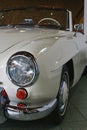 Left front view of front mask and headlight on german luxury two door roadster Mercedes Benz 190 SL from year 1961, white colour