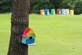 Colourful birdhouse in the green garden