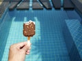 The left hand is holding chocolate ice cream that has already been eaten Royalty Free Stock Photo