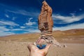 Left hand holding crystal ball in Atacama Pacana Monks Royalty Free Stock Photo