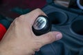 Left hand holding a gear shift lever Royalty Free Stock Photo