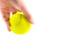 Left hand holding new yellow tennis ball on white background, ready to serve position Royalty Free Stock Photo