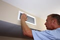 Left Hand of a Mature Man Placed on an Air Vent in a Home on a Wall Royalty Free Stock Photo