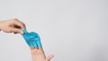 Left hand is pulling right hand with blue latex gloves on white background Royalty Free Stock Photo
