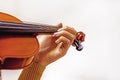 left hand of a young violinist on the strings on a student\'s violin on a light background. Musical education Royalty Free Stock Photo